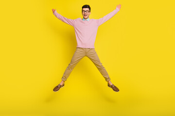 Fototapeta na wymiar Full size photo of young happy positive excited crazy smiling man jumping in star pose isolated on yellow color background
