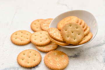 Bowl of crackers on light background
