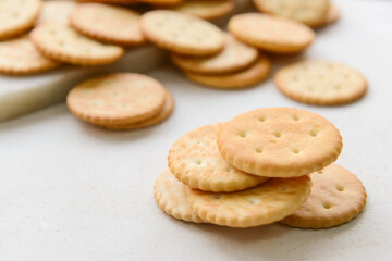 Tasty crackers on light background