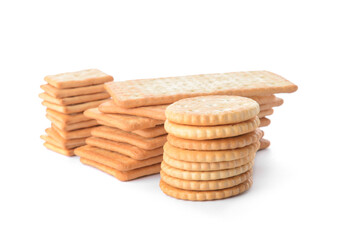 Stacks of tasty crackers on white background