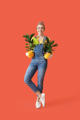 Young female gardener on color background