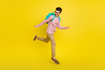 Fototapeta na wymiar Full size photo of young man happy positive smile go walk run jump up look empty space isolated over yellow color background