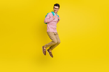 Fototapeta na wymiar Full length photo of young excited man happy positive smile have fun jump up isolated over yellow color background