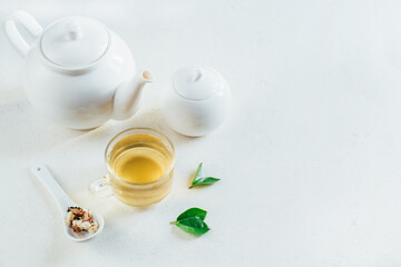 .tea service with tea in a transparent cup on a white background with free space