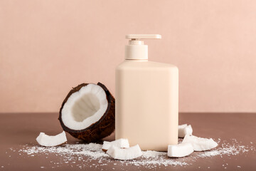Shower gel and coconut on color background