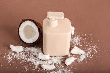 Shower gel and coconut on color background