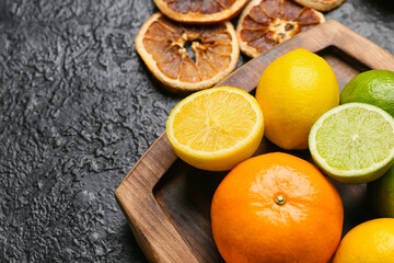 Fresh citrus fruits on dark background