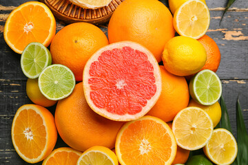 Fototapeta na wymiar Fresh citrus fruits on dark wooden background