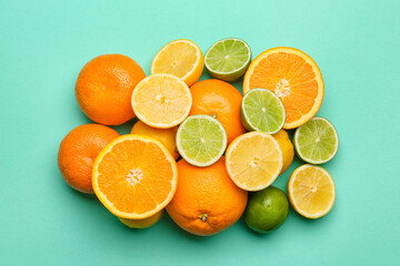 Fresh citrus fruits on color background