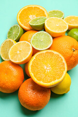 Fresh citrus fruits on color background