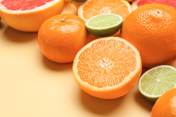 Fresh citrus fruits on color background