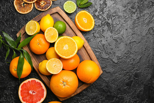 Fresh citrus fruits on dark background © Pixel-Shot