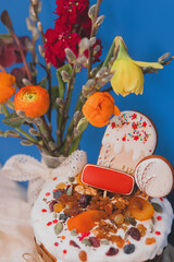 Easter cake, natural Easter panettone with dried fruits, nuts and flowers on holiday festive table