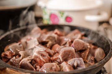 Fried veal liver in a pan. Braised cow and pork liver