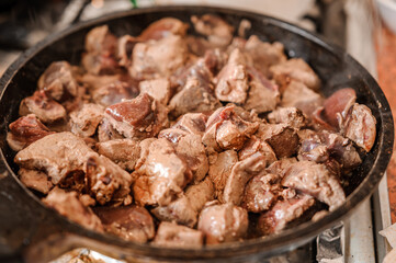 Fried veal liver in a pan. Braised cow and pork liver