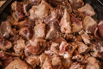 Fried veal liver in a pan. Braised cow and pork liver