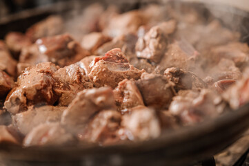 Fried veal liver in a pan. Braised cow and pork liver