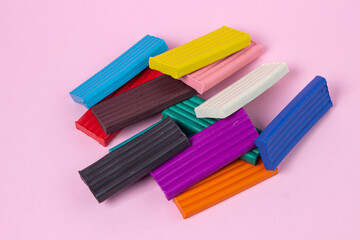 Multi-colored plasticine on a pink background. Educational game. Plasticine set