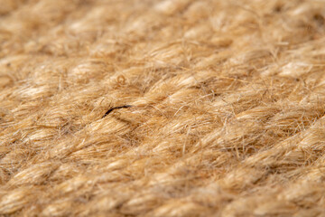 A background of roughly knitted fabric in soft focus under high magnification. Synthetic fabric stylized as an old, chunky-knit linen thread.
