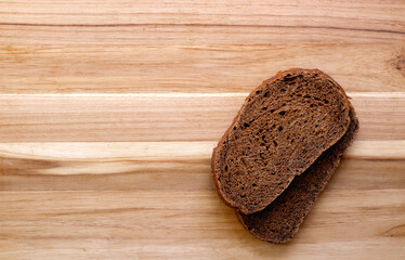 Dark rye bread on cutting board with copy space