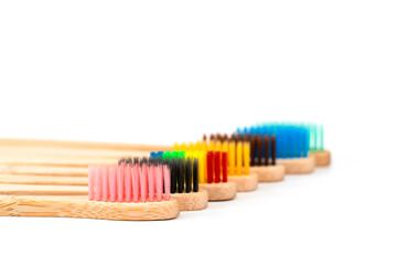 colorful wooden bamboo toothbrushes isolated on white background.