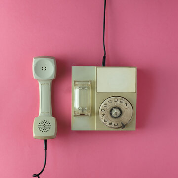 Old Gray Phone On A Pink Background. Flat Lay