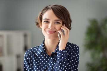 Portrait of attractive pretty cheerful brown-haired girl calling client discussing project order interview at workplace workstation indoors