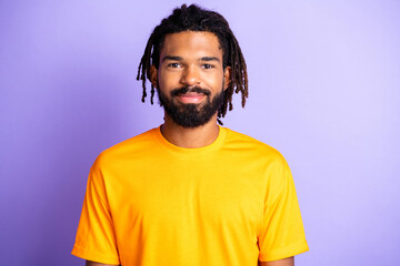Portrait of nice optimistic brunet guy wear orange t-shirt isolated on vibrant lilac color...