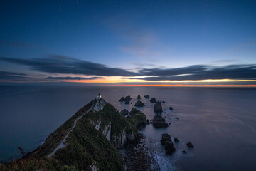 Fototapeta na wymiar Beautiful sunrise at Nugget Point Lighthouse, New Zealand