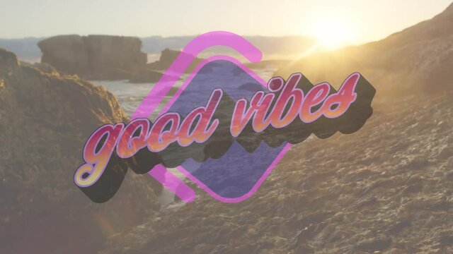 Animation of the words good vibes in orange and purple letters over rocky coast and sea at sunset