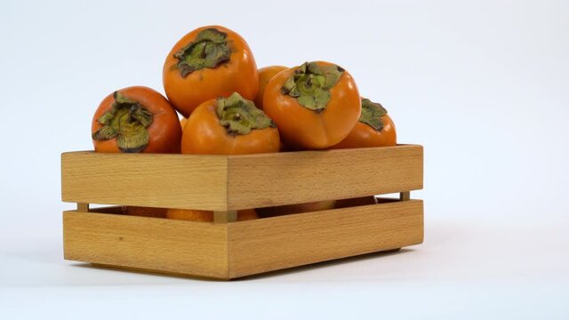 Fruit kinglet on white background. Organic goldcrest in wooden box. Organic, health fruit. Copy space. Food market.
