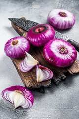 Sliced Flat red sweet onion on a cutting board. White background. Top View