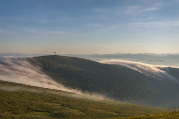 Fototapeta premium dawn mountains fog clouds repeater top