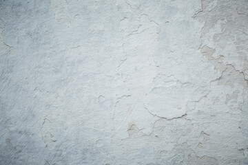 White grey old wall with shabby damaged plaster.