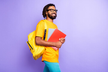 Profile photo of nice optimistic brunet guy hold books wear spectacles bag t-shirt isolated on...