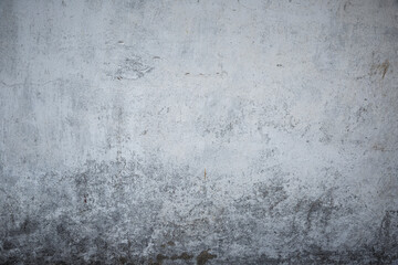 White grey old wall with shabby damaged plaster.