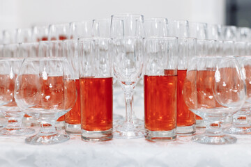 Serving glasses for the festive table. Glasses for spirits, champagne and juice. Set the table. Glasses with compote. Close-up.