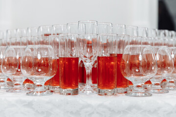 Serving glasses for the festive table. Glasses for spirits, champagne and juice. Set the table. Glasses with compote. Close-up.