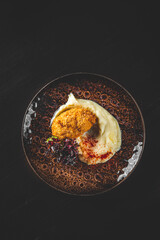 burger with mashed potatoes in white on black wooden background