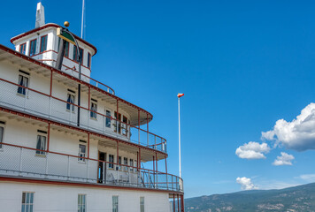 Upper decks of steam vessel on blue sky background