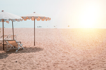Tropical Beach Getaway: Deckchairs and White Parasol under the Summer Sun