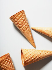 Several ice cream waffle cups on a colored background