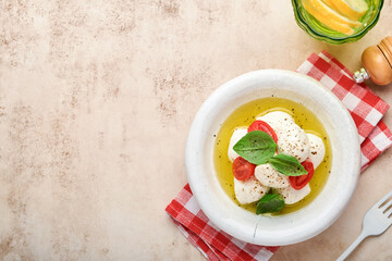 Caprese salad. Mozzarella cheese with basil and cherry tomato in white ceramic plate and tomato cherry on slate stone table background, copy space. Mock up.