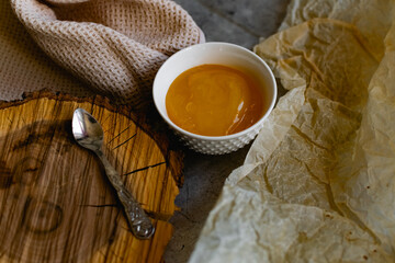 Natural honey herbs, the may. A healthy and nutritious elixir with a sticky consistency in a round bowl on a wooden stand