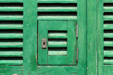 keyhole in rustic green wooden door