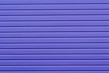 Obraz premium The wall of the house is finished with blue siding.