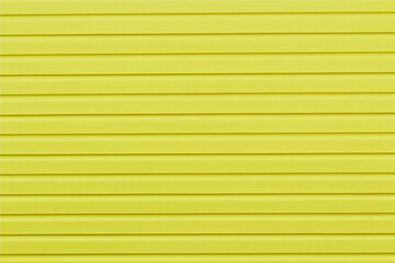 The wall of the house is finished with yellow siding.