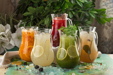 five pitcher with colorful lemonade on the table