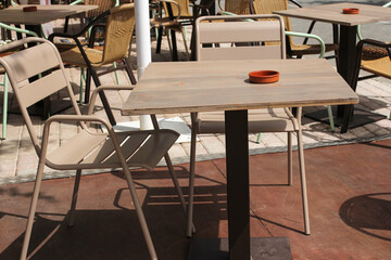empty tables waiting for quests in a street restaurant