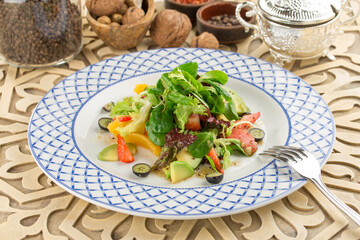 summer Lettuce salad with avocado and strawberry on the table